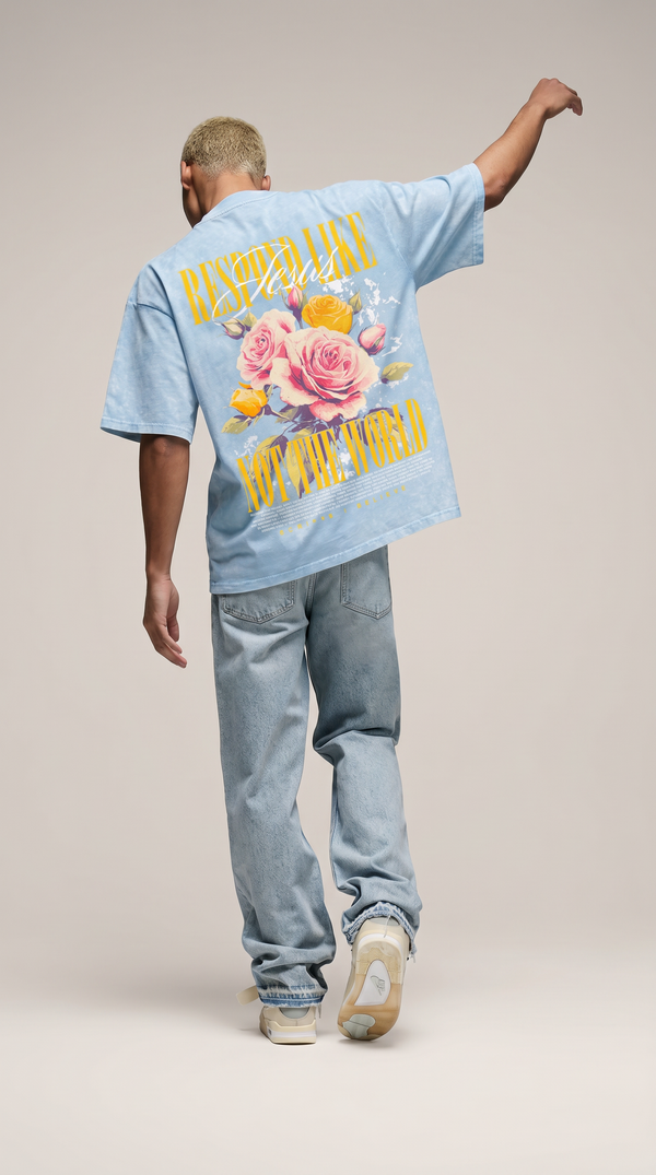 Man wearing light blue oversized "Respond Like Jesus" Christian tee with floral graphic - back view