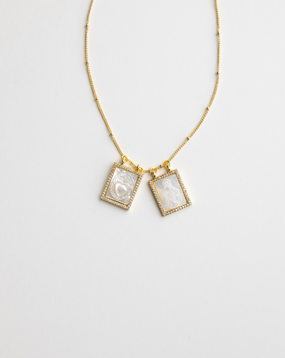 Gold Christian scapular necklace with shell-face pendant detail