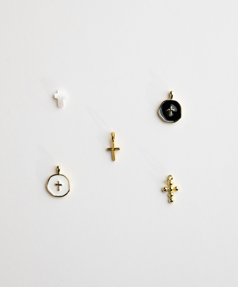 Close-up of cross and religious medal charms for Christian rosary bracelet