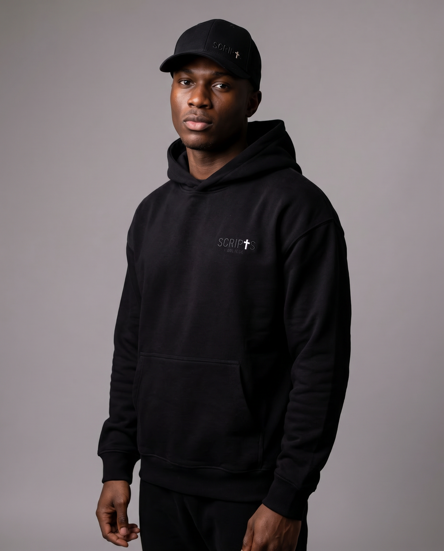 Man wearing black Christian hoodie and "I Believe" baseball cap