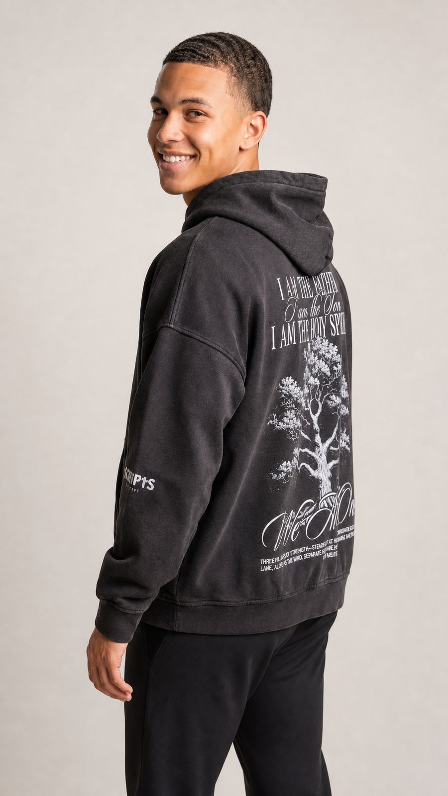 Boy wearing black oversized Holy Trinity Christian fleece hoodie - front view