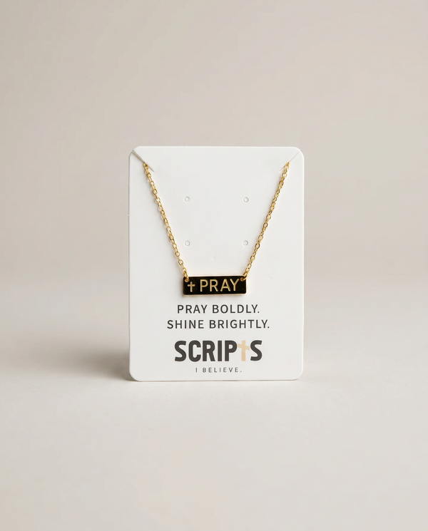 Gold "Pray" necklace on Christian brand display card