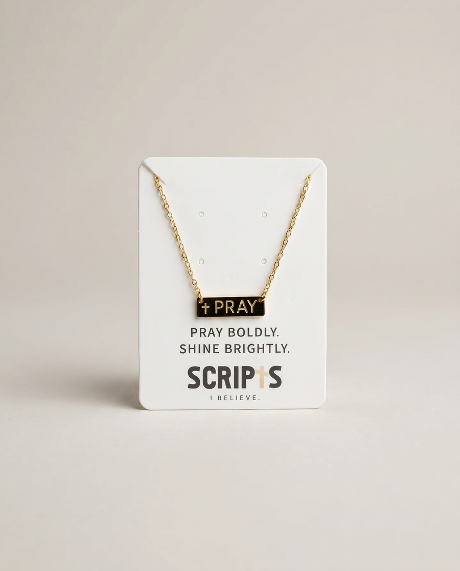 Gold "Pray" necklace on Christian brand display card