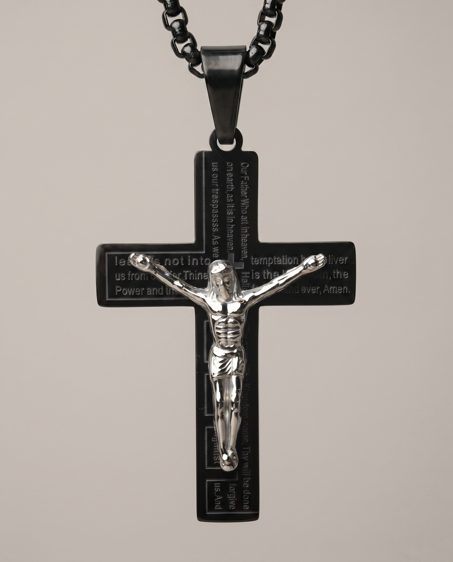 Close-up of crucifix pendant showing engraved Lord's Prayer detail