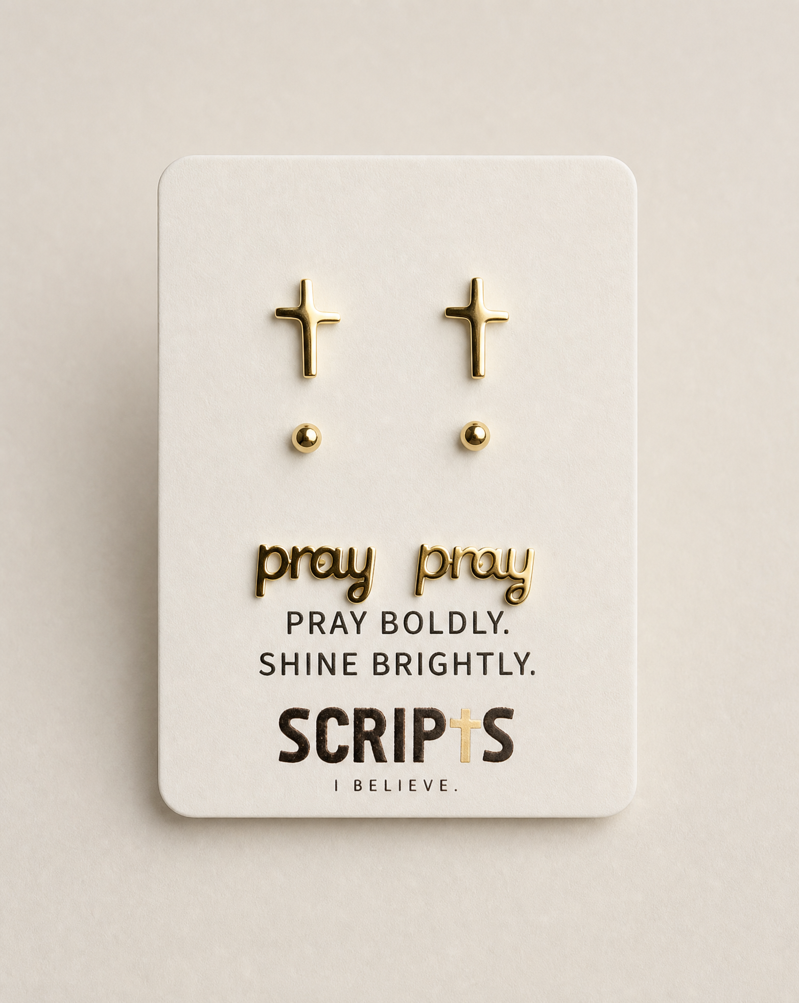 Christian "Pray Boldly, Shine Brightly" cross earrings on display card