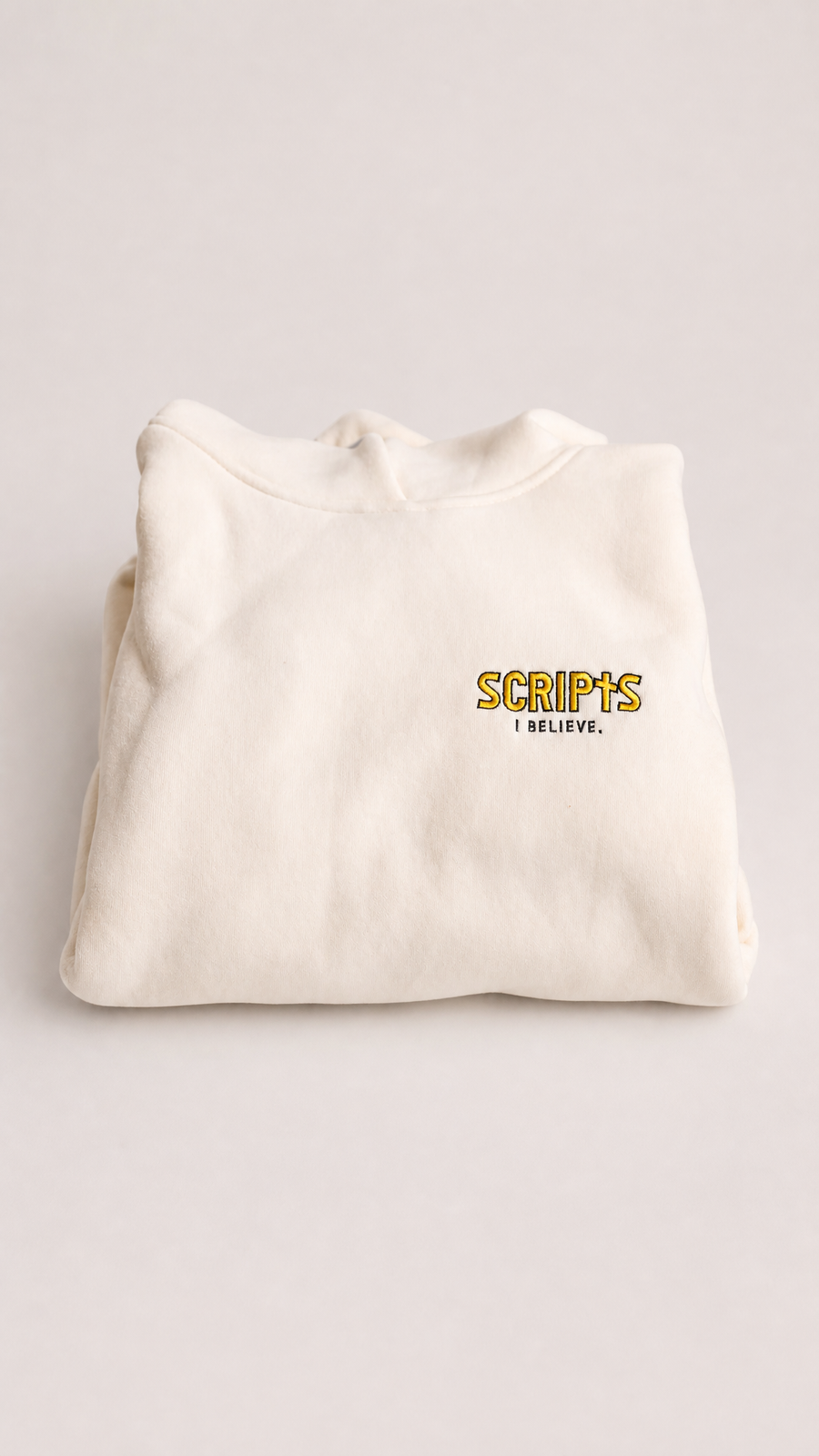 Christian youth fleece hoodie in cream - back view, folded