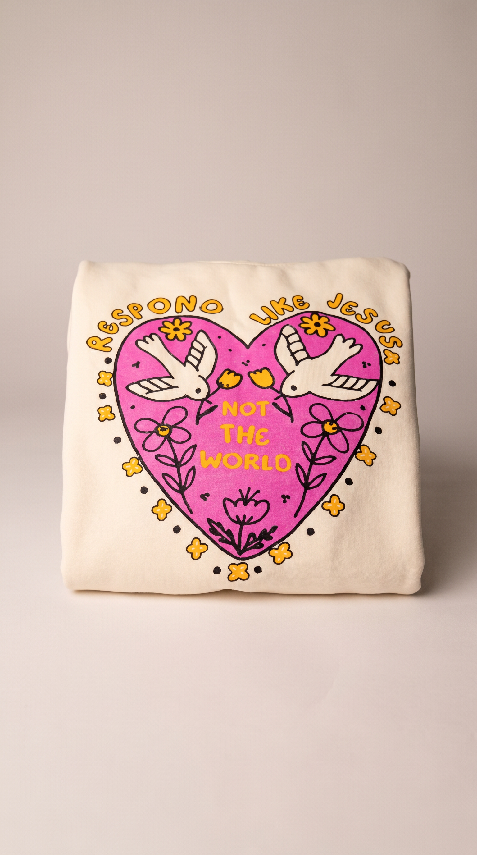 Christian youth hoodie with pink heart graphic "Respond Like Jesus, For the World" and dove design