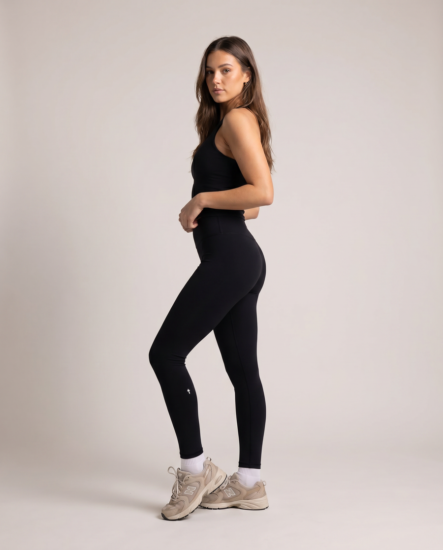 Woman wearing Christian "I Believe" full-length black leggings