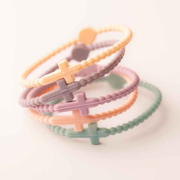Faith Silicone Collection - stacked pastel cross bracelets in orange, lavender, and teal