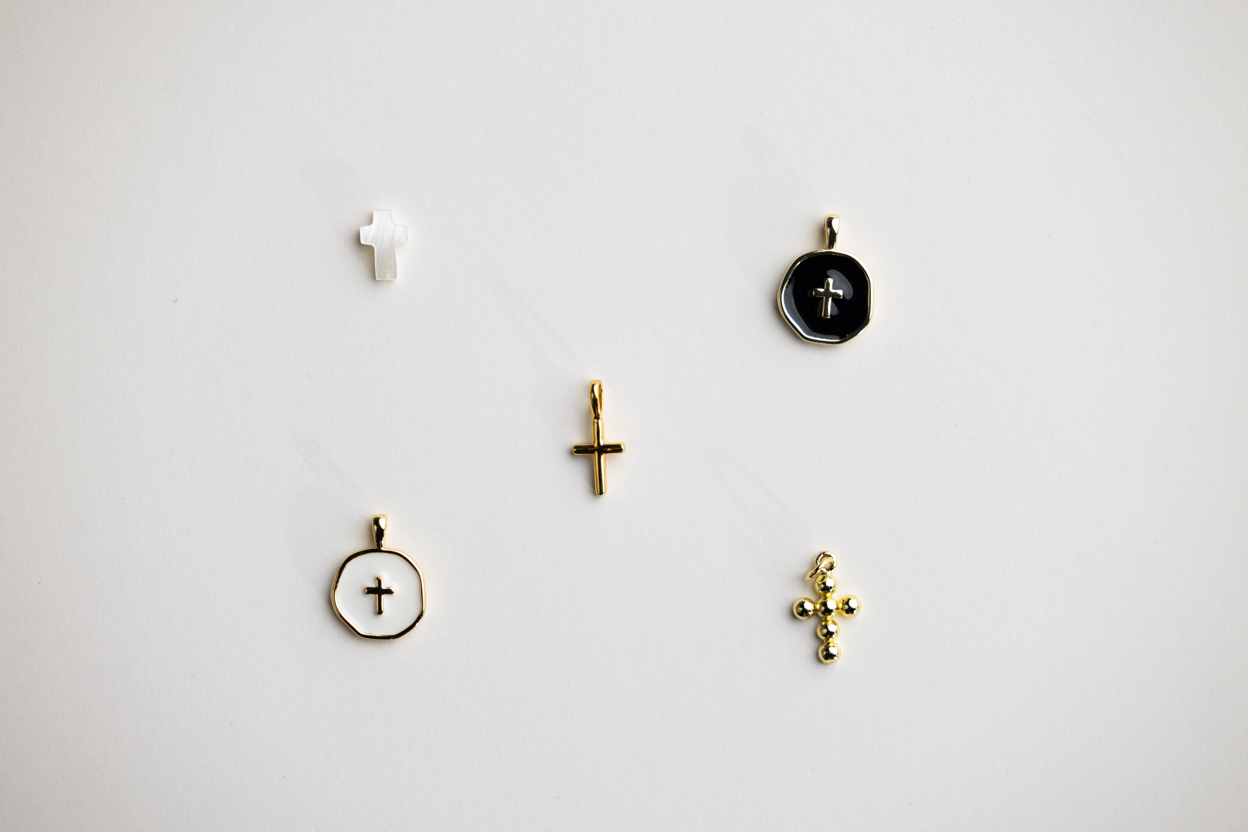 Close-up of cross and religious medal charms for Christian rosary bracelet