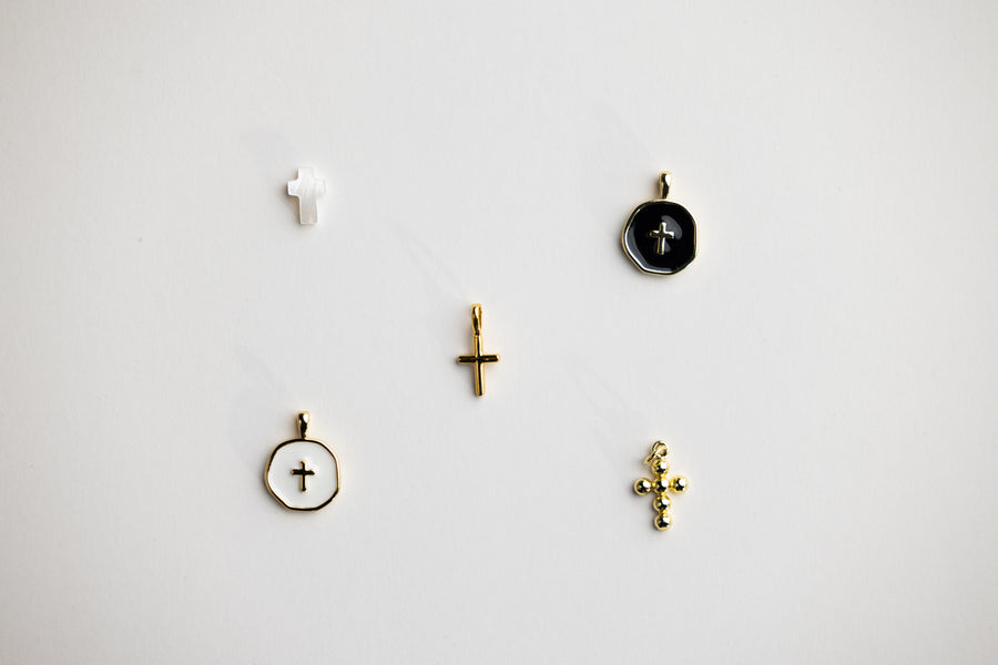 Close-up of cross and religious medal charms for Christian rosary bracelet