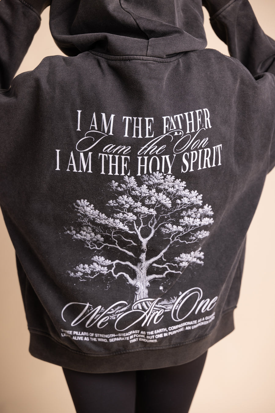 Black Holy Trinity hoodie back design with tree graphic and "I Am the Father, I Am the Son, I Am the Holy Spirit" text
