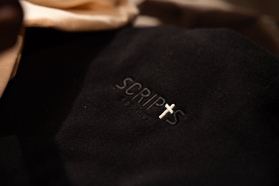 Close-up of Christian streetwear hoodie fabric with "SCRIPTS" embroidered detail
