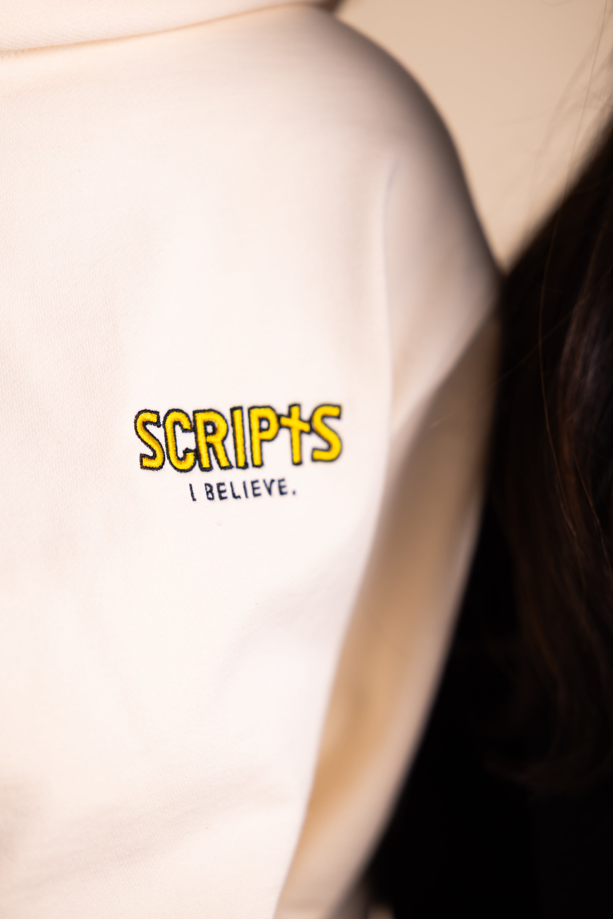 Close-up of Christian streetwear hoodie with "SCRIPTS" embroidered detail