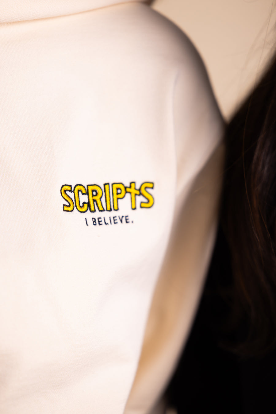 Close-up of Christian streetwear hoodie with "SCRIPTS" embroidered detail
