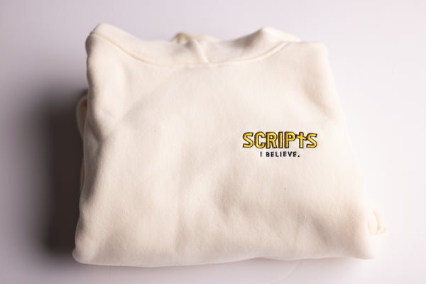 Christian beige fleece hoodie folded with "SCRIPTS, I Believe" embroidered detail