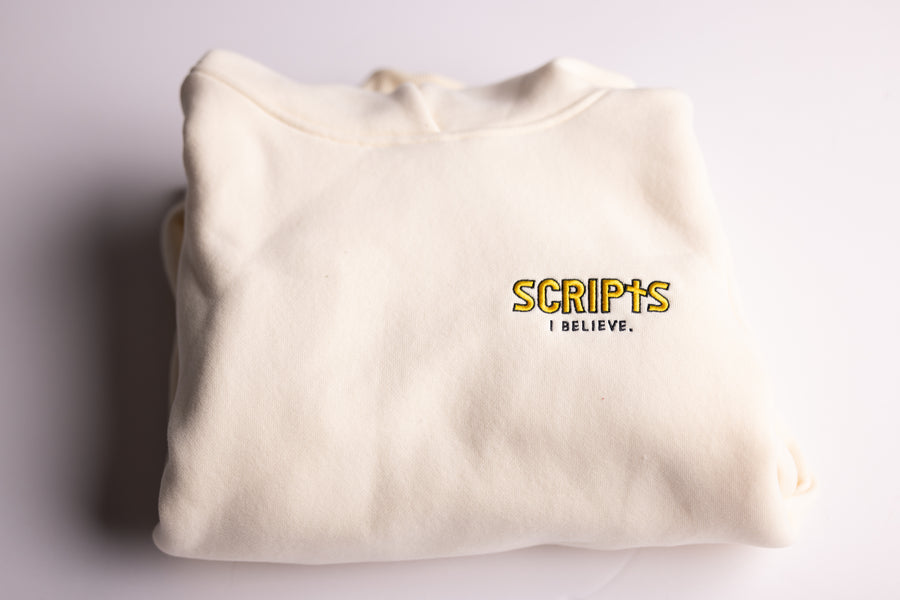 Christian beige fleece hoodie folded with "SCRIPTS, I Believe" embroidered detail