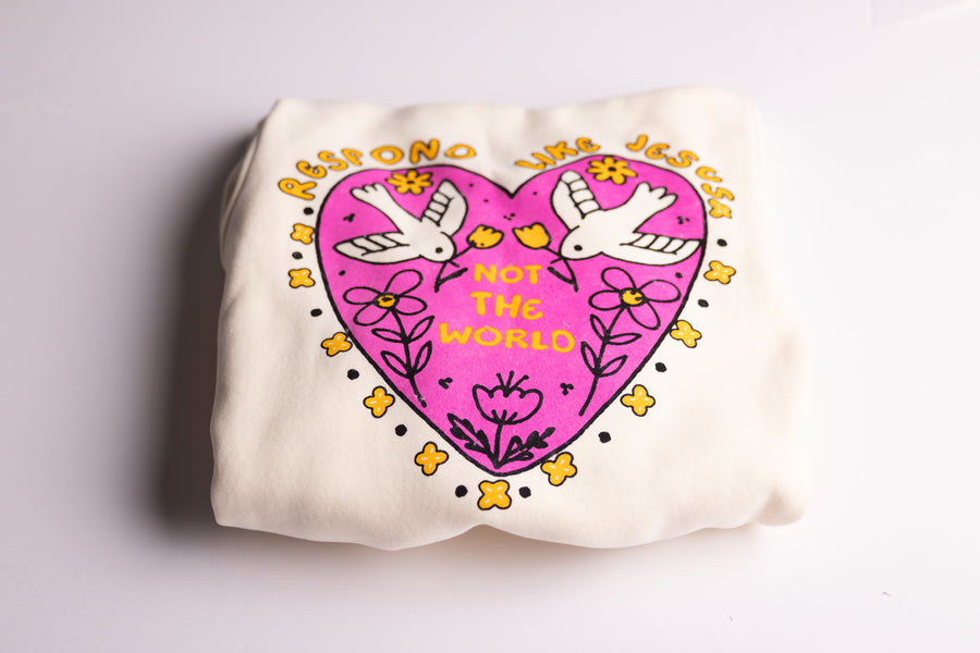 Christian youth hoodie folded showing pink "Respond Like Jesus" heart graphic