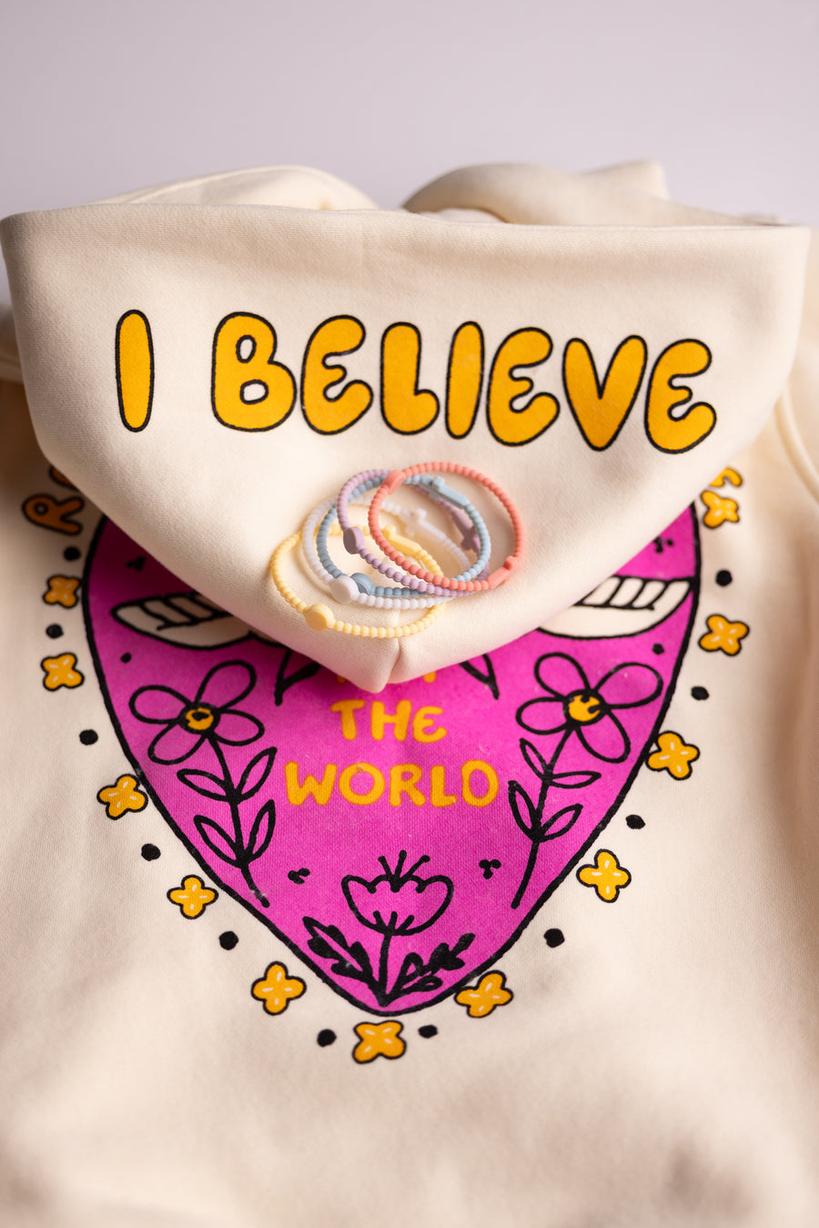 Close-up of Christian "I Believe" heart graphic on youth fleece hoodie