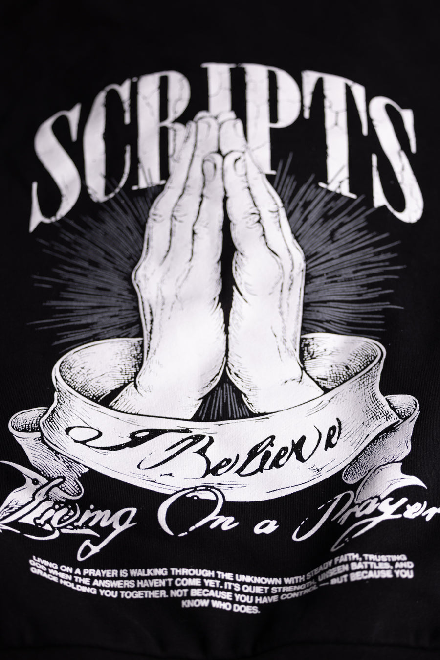 Christian streetwear graphic - praying hands design with "SCRIPTS, I Believe, Living on a Prayer" text