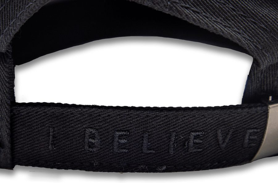 Black Christian cap interior showing hidden "I Believe" stitched message
